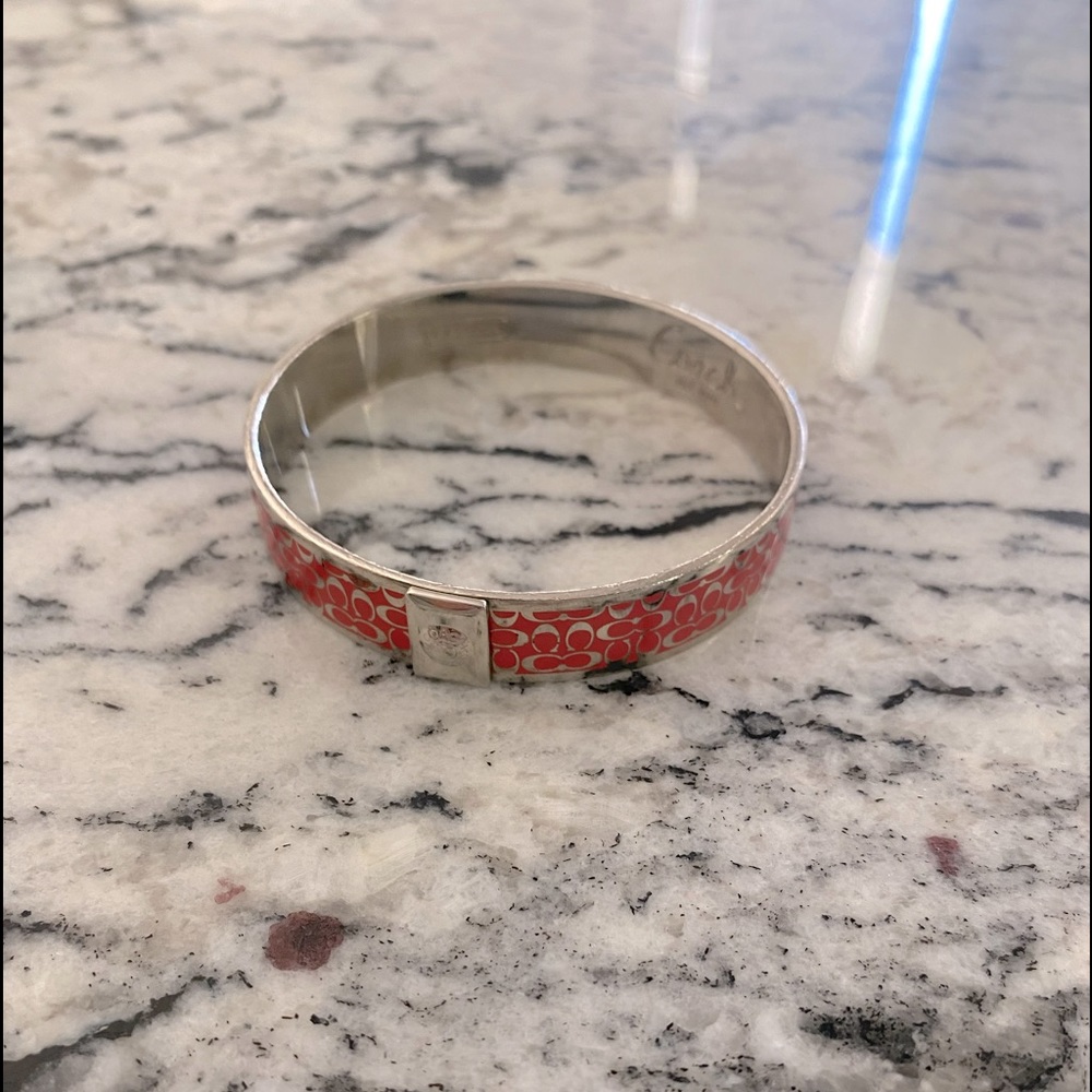 Beautiful coral and silver Coach bracelet.  It is in perfect condition.